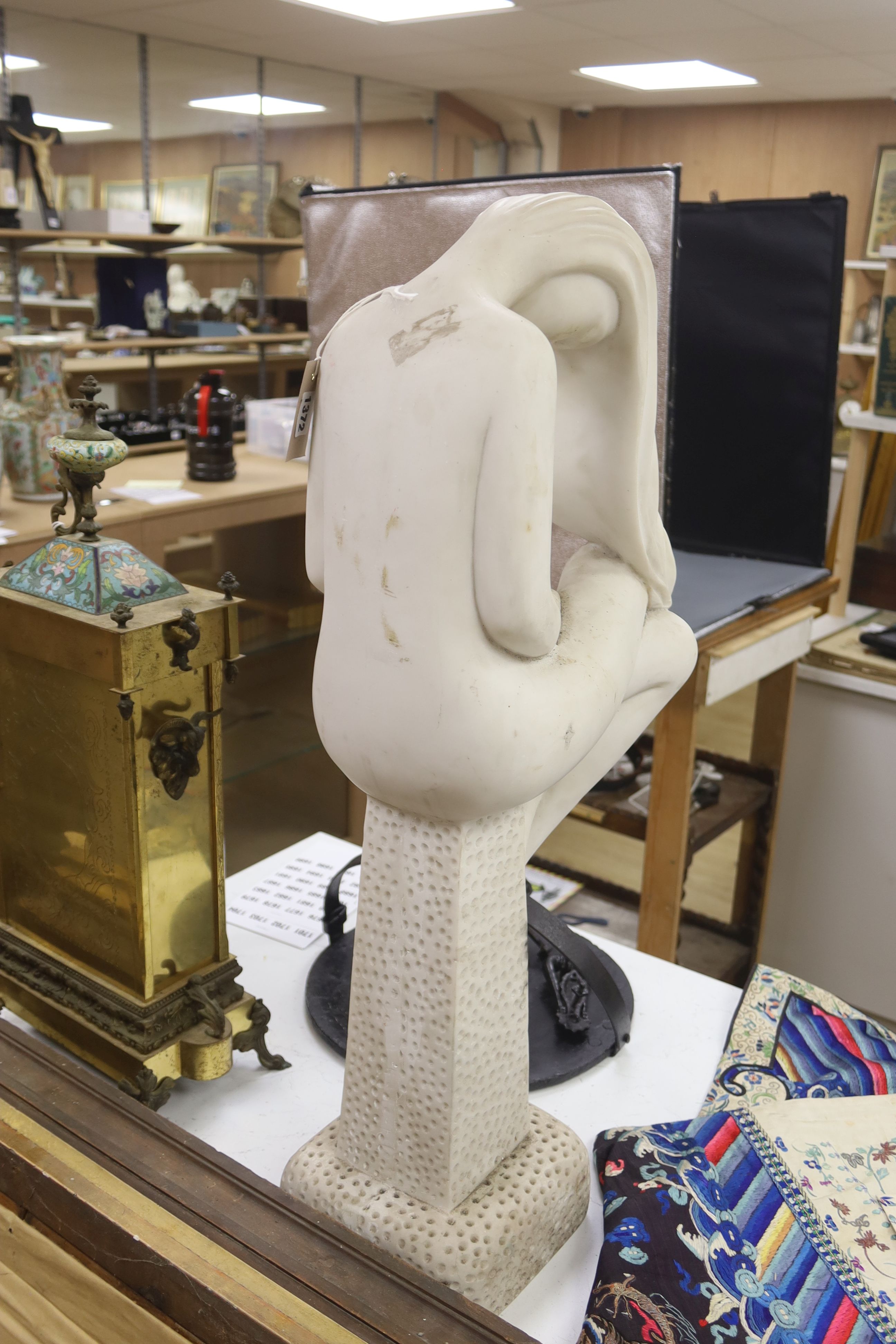 A faux marble figure of a seated nude, on plinth, height 81cm